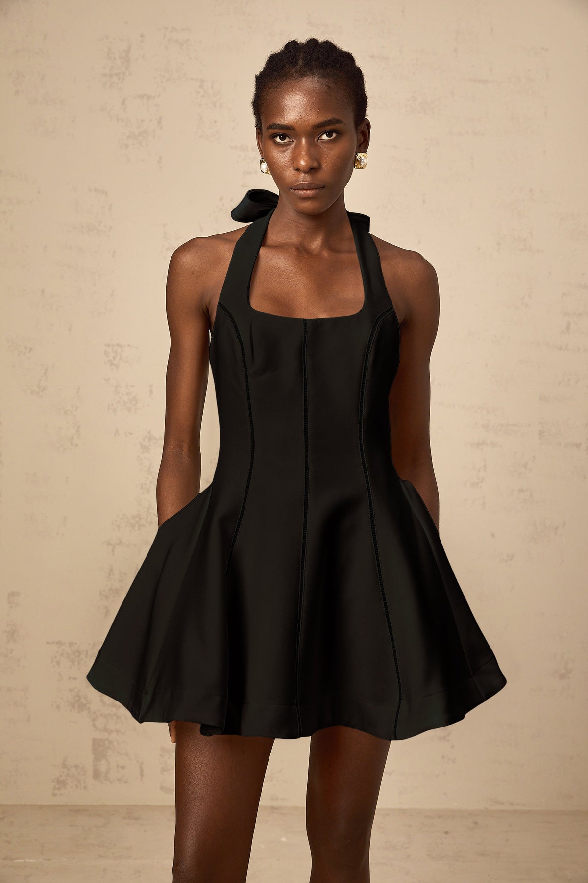 Quirine halterneck bow-detail mini dress in Black