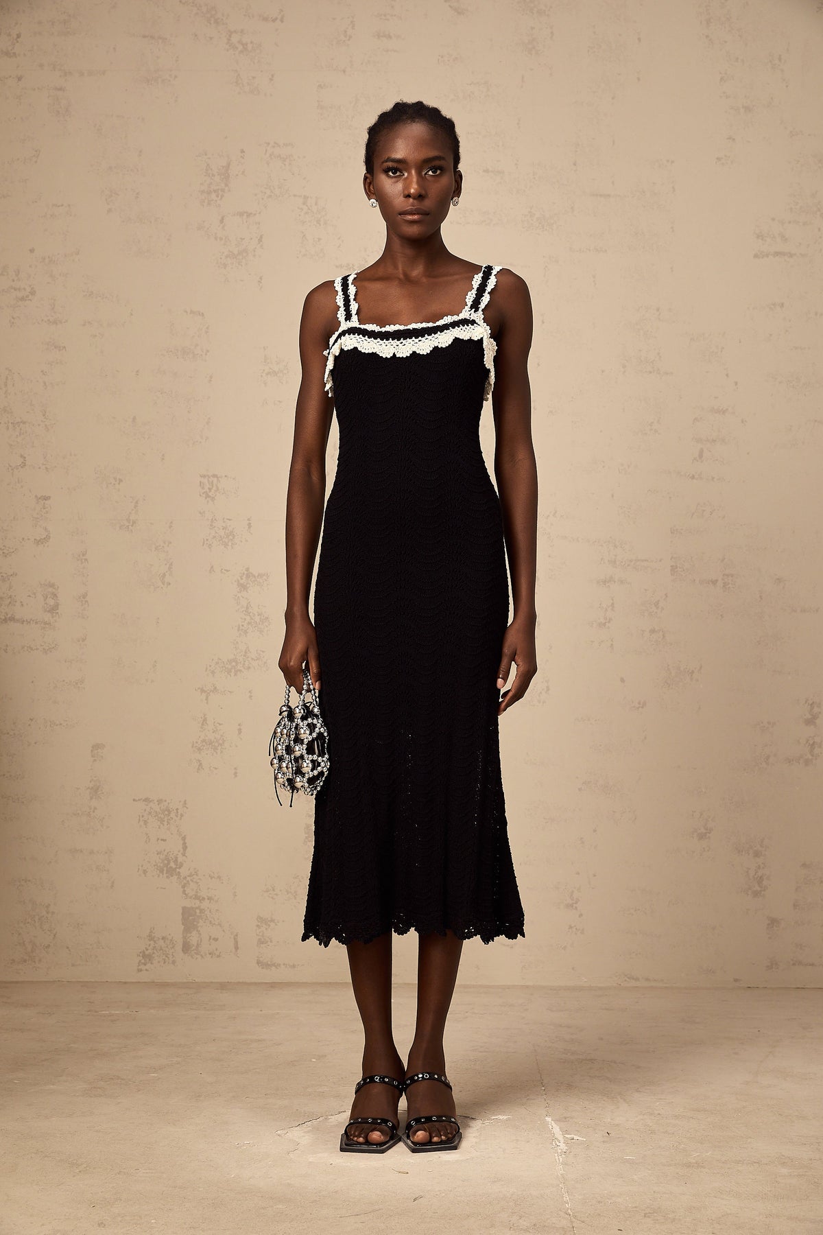 Noémie black sleeveless crochet-knit midi dress